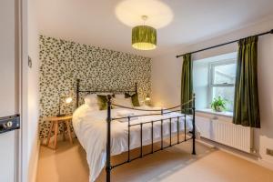a bedroom with a bed and a window at 3 Bed in Caldbeck oc-h30704 in Caldbeck