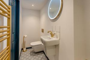 a bathroom with a sink and a toilet and a mirror at 3 Bed in Caldbeck oc-h30704 in Caldbeck +24 photos