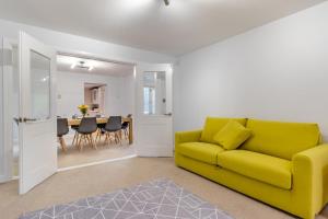 a living room with a yellow couch and a table at 4 Bed in Caistor oc-t30831 in Caistor