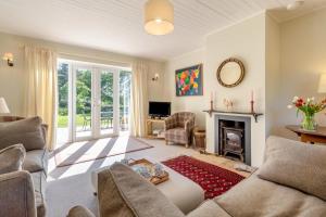 a living room with a couch and a fireplace at 2 Bed in Kettlestone oc-t32268 in Little Snoring