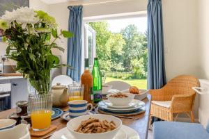 a dining room table with breakfast food on it at 2 Bed in Kettlestone oc-t32268 in Little Snoring