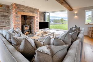 a living room with a couch and a fireplace at 6 Bed in Llanwern oc-w31947 in Brecon