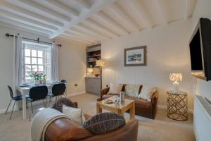 a living room with a couch and a table at 2 Bed in Aberaeron oc-bow173 in Aberaeron