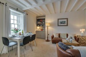 a living room with a table and chairs and a couch at 2 Bed in Aberaeron oc-bow173 in Aberaeron