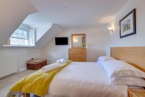 a bedroom with a large bed with towels on it at 2 Bed in Aberaeron oc-bow173 in Aberaeron