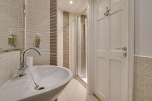 a white bathroom with a tub and a shower at 2 Bed in Aberaeron oc-bow173 in Aberaeron +22 photos