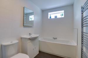 a bathroom with a toilet and a sink and a bath tub at 2 Bed in Gower oc-hh487 in Penclawdd +4 photos