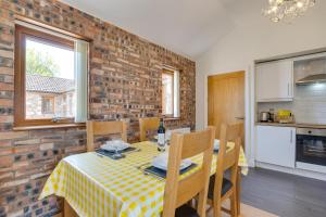 a kitchen and dining room with a table and chairs at 2 Bed in Gower oc-hh487 in Penclawdd