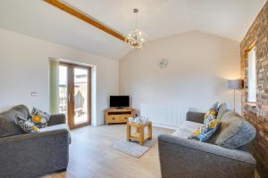 a living room with two couches and a tv at 2 Bed in Gower oc-hh487 in Penclawdd