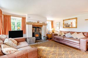 a living room with two couches and a fireplace at 4 Bed in Arne oc-wy343 in Arne