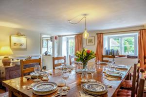 a dining room with a wooden table with wine glasses at 4 Bed in Arne oc-wy343 in Arne