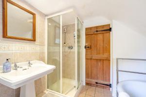 a bathroom with a sink and a shower at 4 Bed in Arne oc-wy343 in Arne +14 photos
