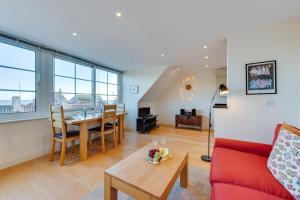 a living room with a red couch and a table at 1 Bed in Aldeburgh oc-sld in Aldeburgh
