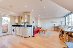 a kitchen and living room with a red couch at 1 Bed in Aldeburgh oc-sld in Aldeburgh