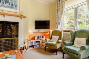 a living room with two chairs and a fireplace at 1 Bed in Sizewell oc-gdnf in Sizewell