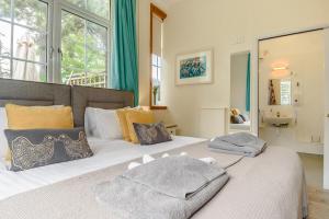 a bedroom with two beds with towels on them at 1 Bed in Sizewell oc-gdnf in Sizewell