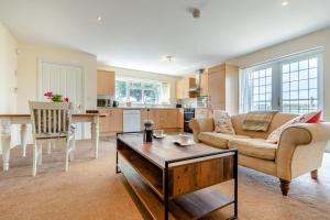 a living room with a couch and a table at 1 Bed in Flore oc-b32437 in Flore +18 photos