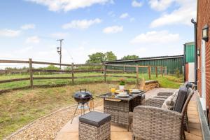 a patio with a grill and chairs and a table at 1 Bed in Flore oc-b32437 in Flore