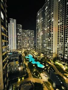 a view of a city at night with tall buildings at 2 Bedrooms Masterise Center Point C Vinhomes Grand Park in Long Bình