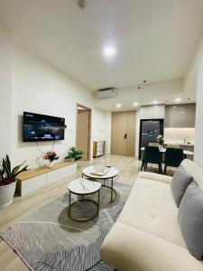 a living room with a couch and a table at 2 Bedrooms Masterise Center Point C Vinhomes Grand Park in Long Bình