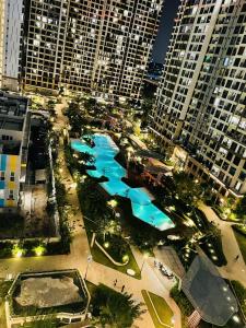 an aerial view of a pool in a city with tall buildings at 2 Bedrooms Masterise Center Point C Vinhomes Grand Park in Long Bình