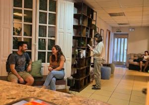 a group of people sitting in a living room at Hostel Cangas Backpackers in Cangas de Morrazo