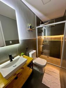 a bathroom with a white sink and a toilet at Vibe Amazon in Manaus +54 photos