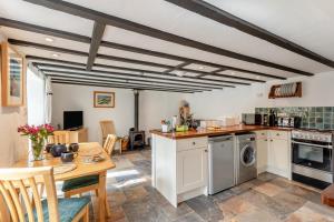 a kitchen with a table and a dining room at 2 Bed in Chideock oc-g32451 in Chideock