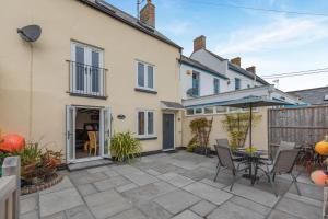 a patio with an umbrella and a table and chairs at 2 Bed in Chideock oc-g32451 in Chideock