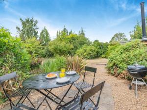 a patio with a table and chairs and a grill at 1 Bed in Luddenham oc-s32602 in Luddenham