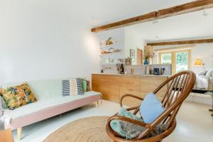 a living room with a couch and a chair at 1 Bed in Luddenham oc-s32602 in Luddenham