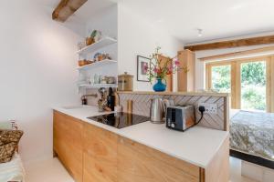 a kitchen with white walls and a counter with a microwave at 1 Bed in Luddenham oc-s32602 in Luddenham