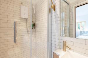 a bathroom with a shower with a sink and a mirror at 1 Bed in Luddenham oc-s32602 in Luddenham