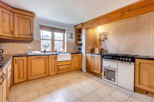 a kitchen with wooden cabinets and white appliances at 5 Bed in Devils Bridge oc-t13712 in Devils Bridge