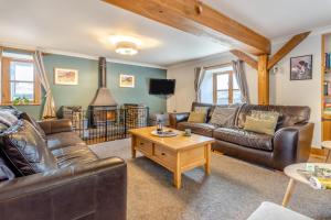 a living room with leather couches and a coffee table at 5 Bed in Devils Bridge oc-t13712 in Devils Bridge