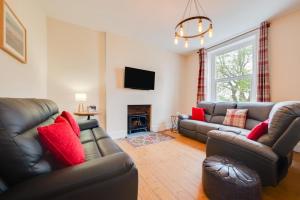 a living room with two couches and a fireplace at 5 Bed in Llandovery oc-bow323 in Llangadog