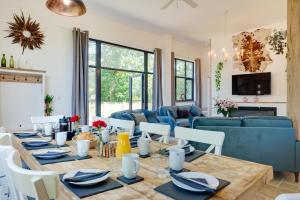 a dining room with a table and a blue couch at 5 Bed in Briston oc-2304 in Briston