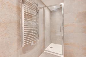 a shower with a glass door in a bathroom at 5 Bed in Briston oc-2304 in Briston +24 photos