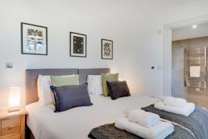 a bedroom with a large white bed with two pillows at 5 Bed in Briston oc-2304 in Briston
