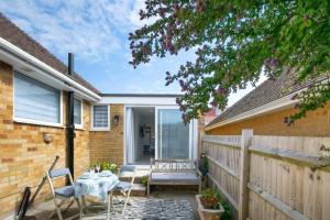 a patio of a house with a table and chairs at 1 Bed in Saltdean oc-bbidre in Saltdean