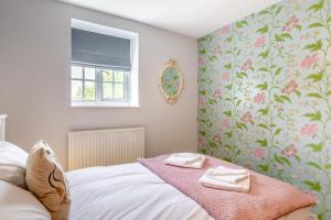 a bedroom with a bed with towels on it at 2 Bed in Stoke Abbott oc-r31870 in Stoke Abbott
