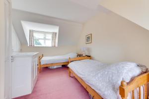 a bedroom with two beds and a window at 3 Bed in Littlestone oc-bt009 in New Romney