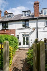 a white house with a fence in front of it at 3 Bed in Littlestone oc-bt009 in New Romney