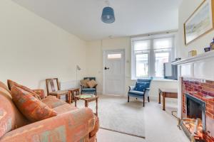 a living room with a couch and a fireplace at 3 Bed in Littlestone oc-bt009 in New Romney
