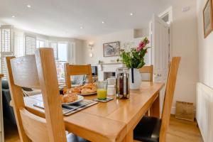 a wooden table with a plate of food on it at 2 Bed in Southwold oc-hdoubl in Southwold