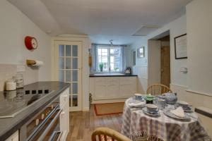 a kitchen with a table with a table cloth on it at 2 Bed in Long Melford oc-9ws in Long Melford