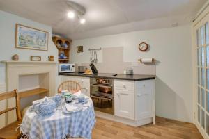a kitchen with a table with a table cloth at 2 Bed in Long Melford oc-9ws in Long Melford +7 photos