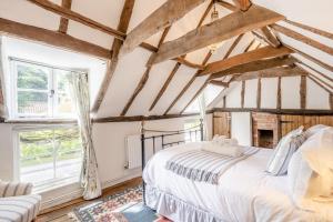 a bedroom with a large bed and a couch at 2 Bed in Dedham oc-c32543 in Dedham