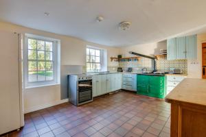 a kitchen with green cabinets and green appliances at 3 Bed in Bungay oc-taf in Bungay