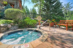 a small swimming pool in a yard with a bench at Elkhorn Lodge, A Vail Resorts Property in Avon